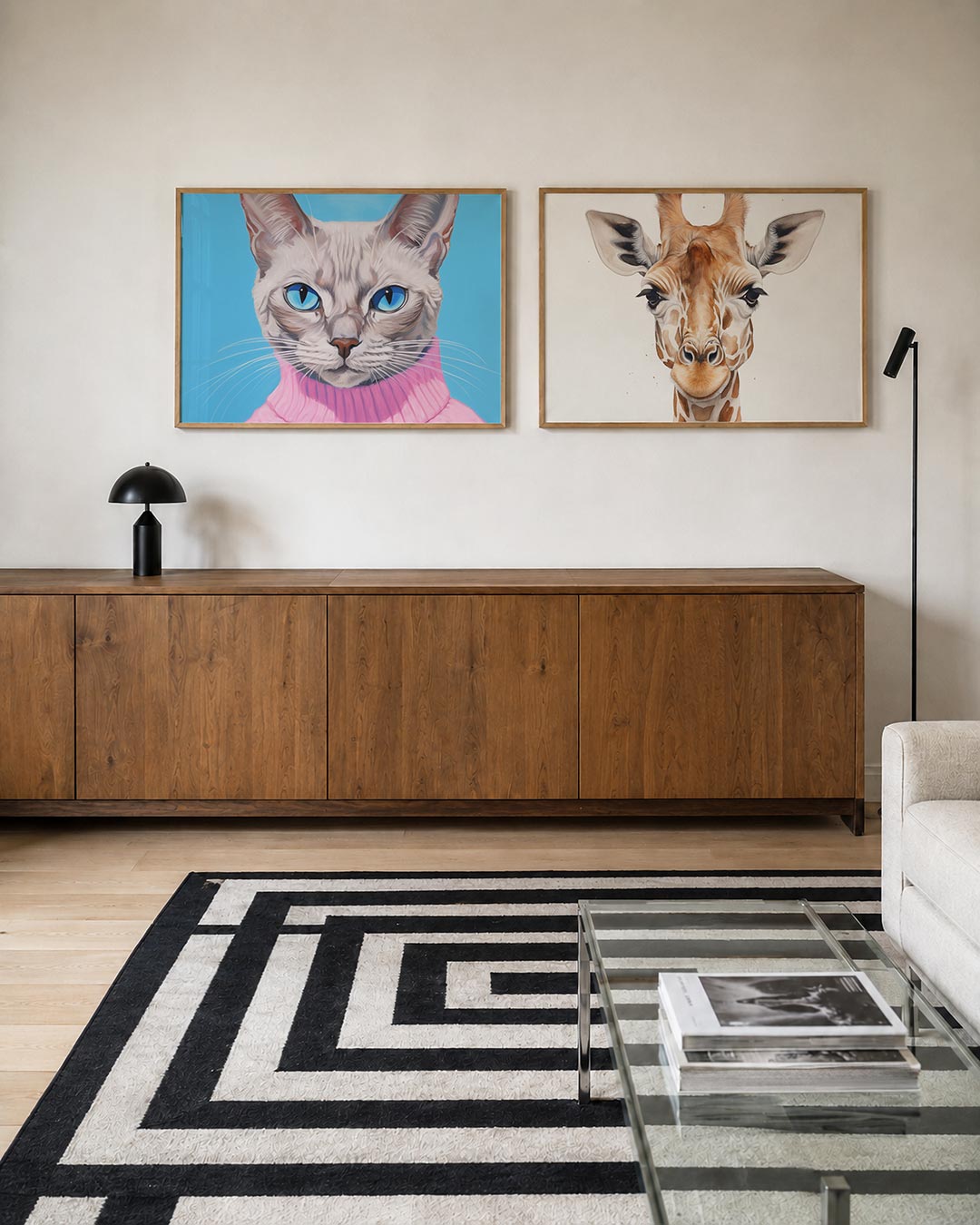Twee liggende posters met een kat met helderblauwe ogen en een roze trui, aan de muur in een interieur