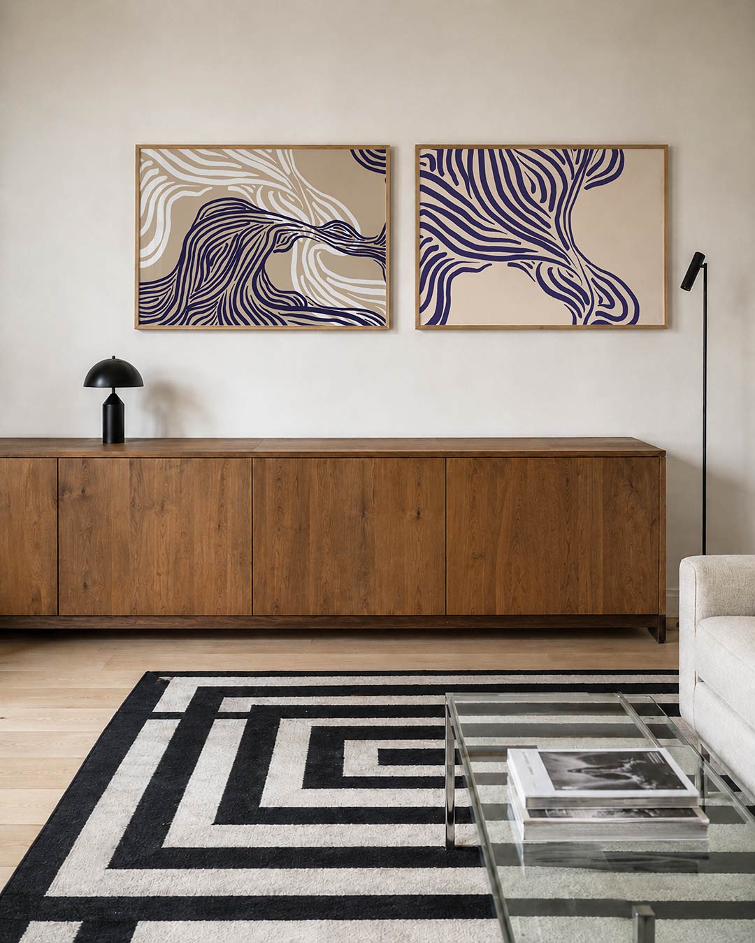 Twee liggende posters met vloeiende, golvende lijnen in donkerblauw en wit op een beige, aan de muur in een interieur